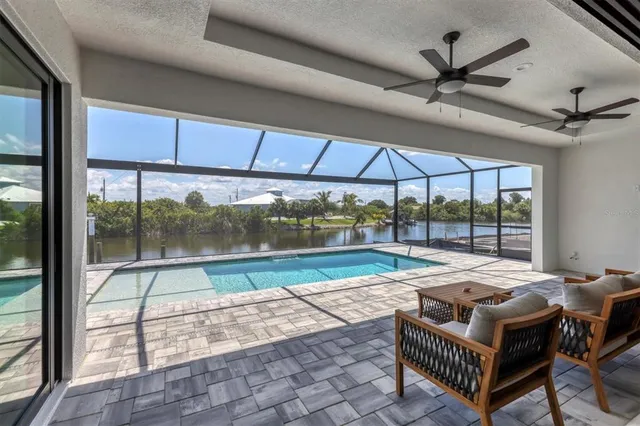 a room with pool table and windows