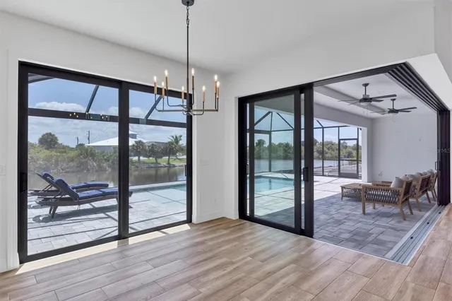 a view of empty room with wooden floor and floor to ceiling window