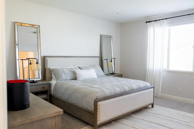 a bedroom with a bed and window