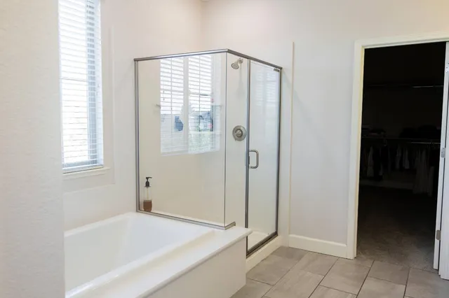 a bathroom with a bathtub and a shower