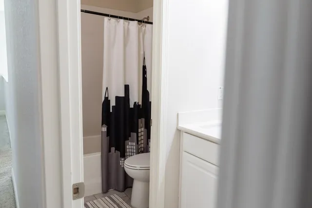 a bathroom with a toilet and a shower