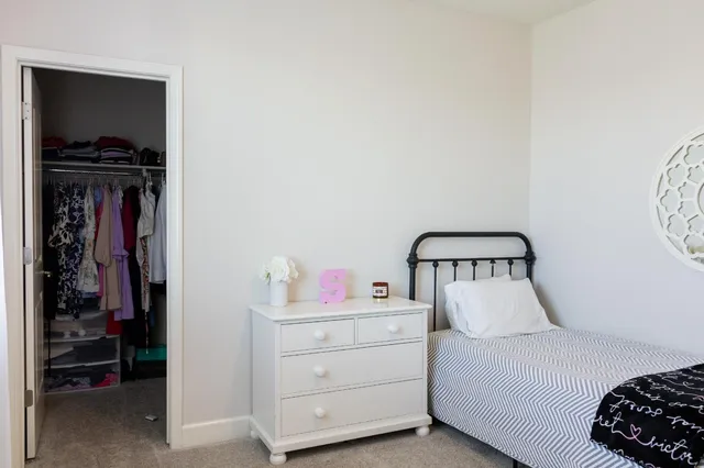 a bedroom with a bed and a closet