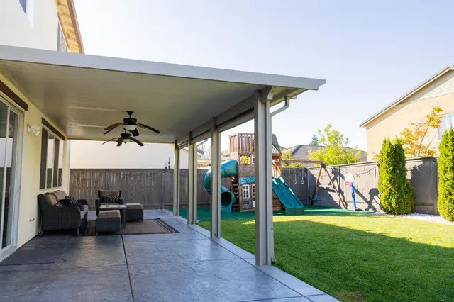 a view of a porch with furniture and a yard