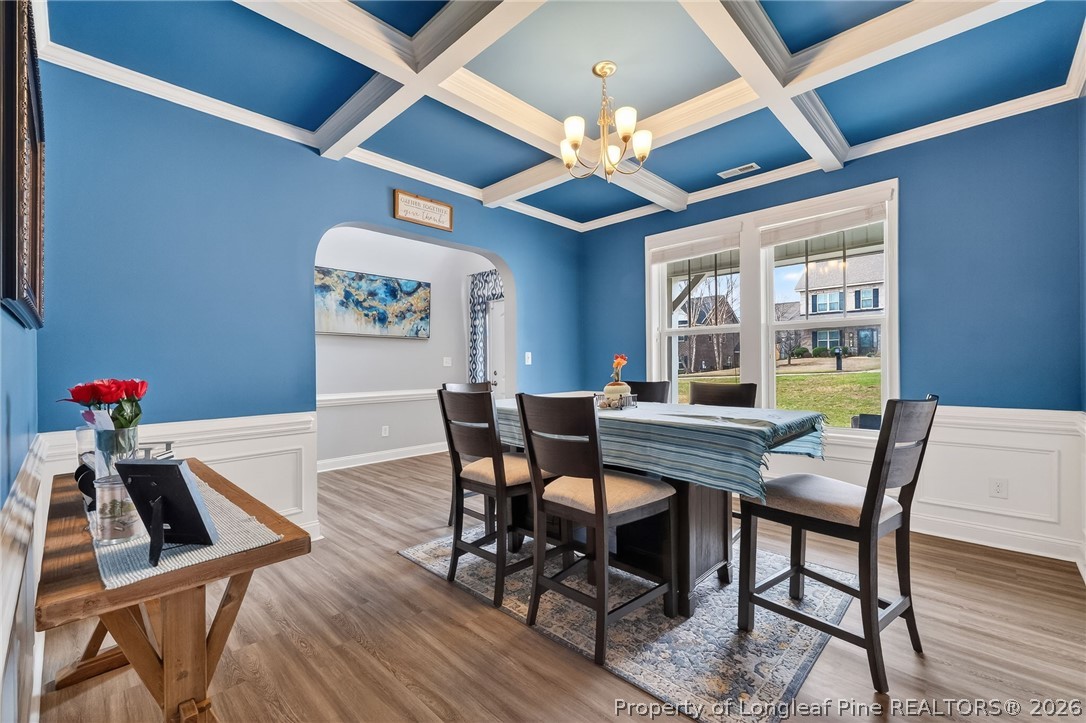 5129 Carson Allen Road Hope Mills, NC 28348 - Photo 13 of 50 a view of a dining room with furniture a chandelier and wooden floor