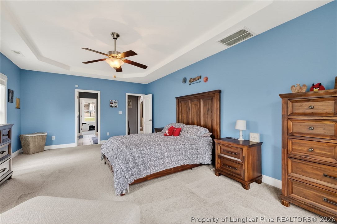 5129 Carson Allen Road Hope Mills, NC 28348 - Photo 14 of 50 a bedroom with a bed and dresser
