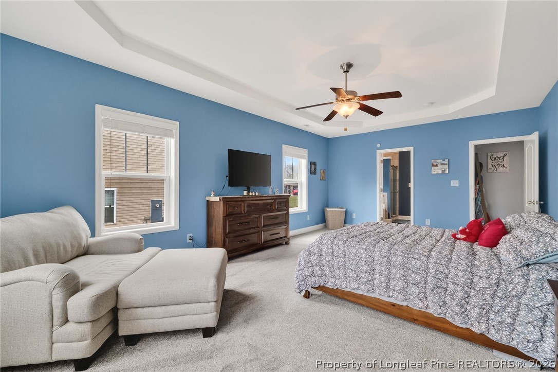 5129 Carson Allen Road Hope Mills, NC 28348 - Photo 15 of 50 a bedroom with a bed couches dresser and a flat screen tv