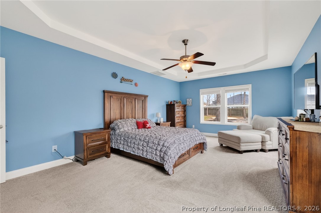 5129 Carson Allen Road Hope Mills, NC 28348 - Photo 17 of 50 a spacious bedroom with a bed couch and window