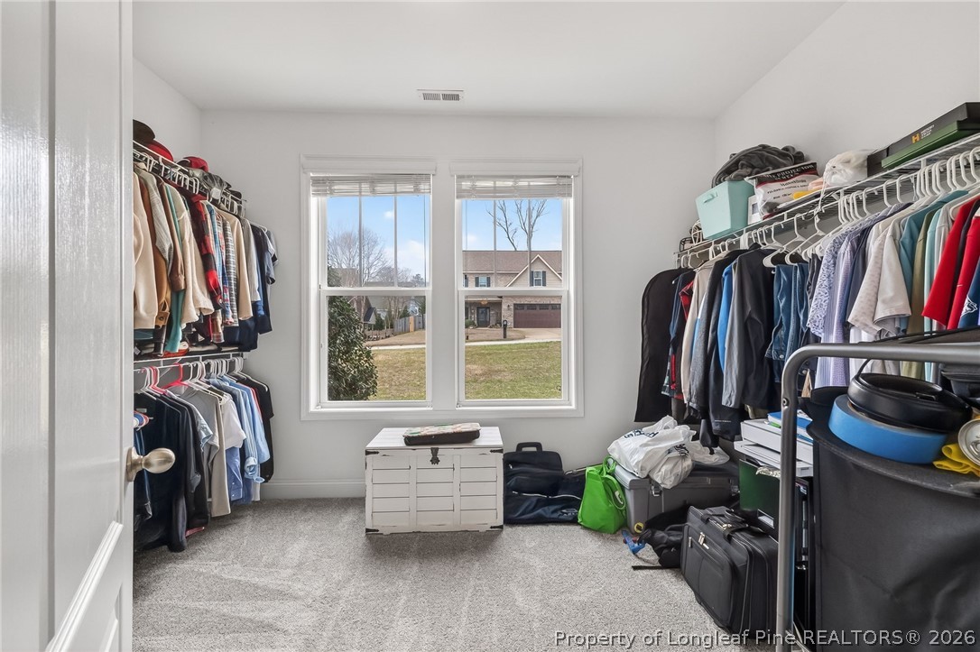 5129 Carson Allen Road Hope Mills, NC 28348 - Photo 18 of 50 a view of walk in closet with clothes and shoes