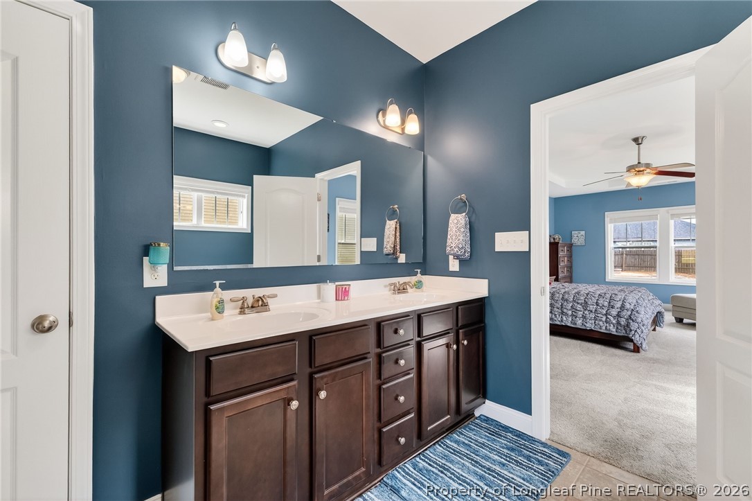 5129 Carson Allen Road Hope Mills, NC 28348 - Photo 19 of 50 a bathroom with a double vanity sink a mirror and a bathtub