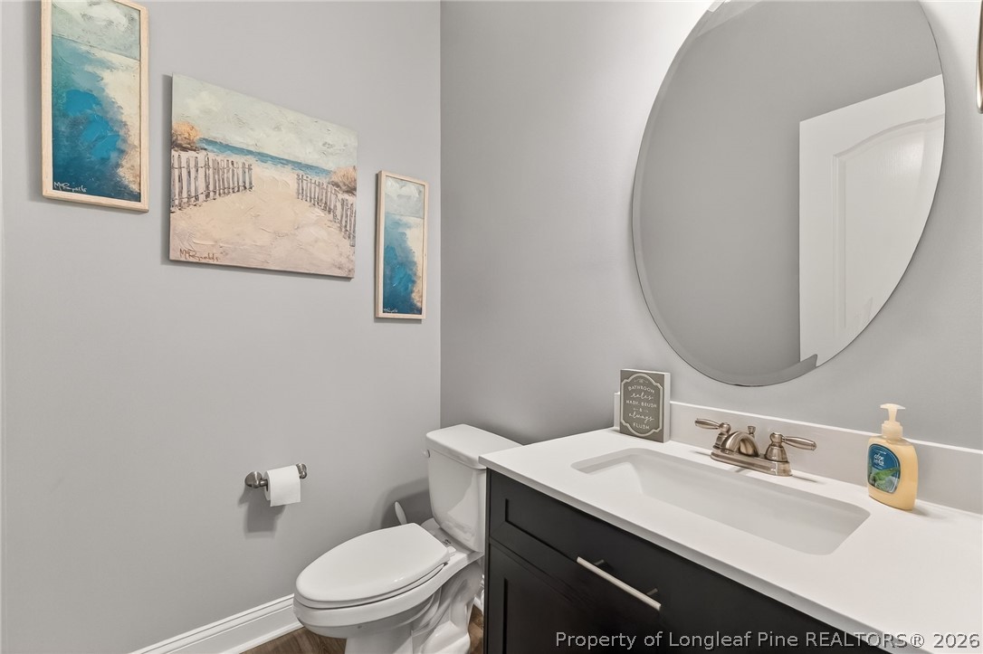 5129 Carson Allen Road Hope Mills, NC 28348 - Photo 24 of 50 a bathroom with a toilet a sink and mirror
