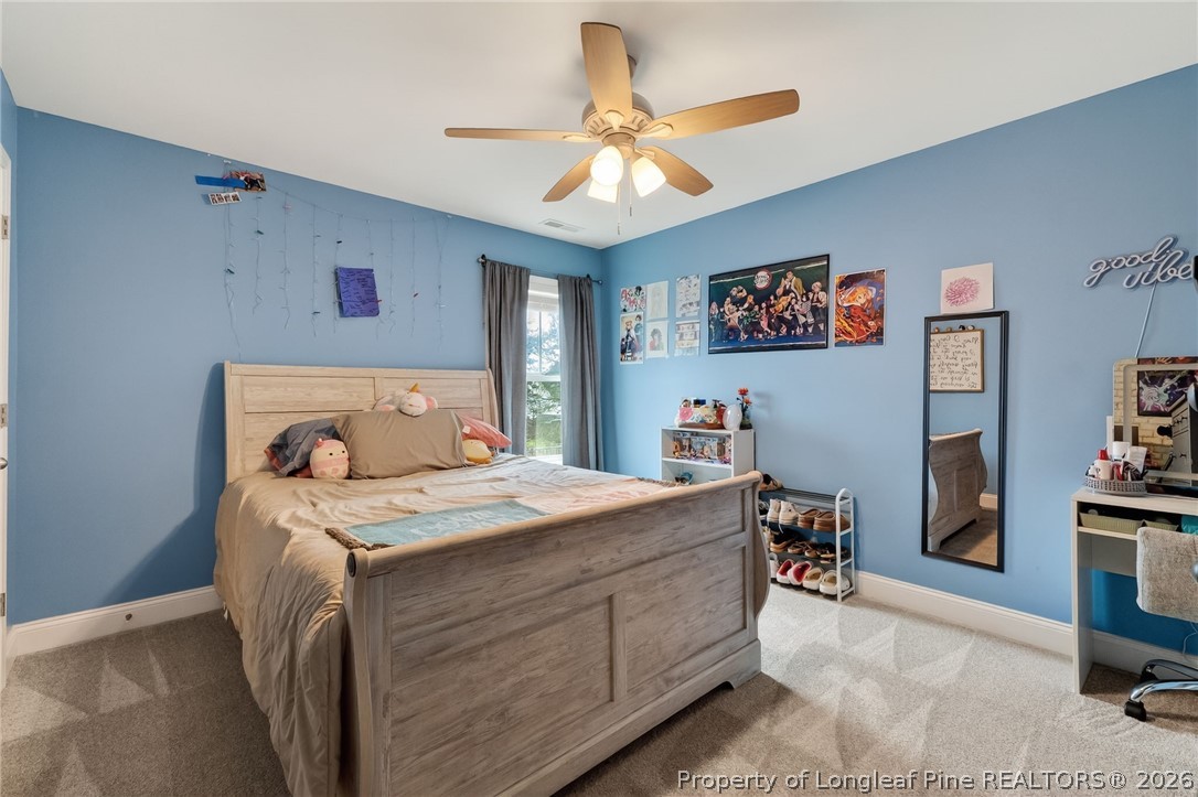 5129 Carson Allen Road Hope Mills, NC 28348 - Photo 27 of 50 a bedroom with a bed and a chandelier