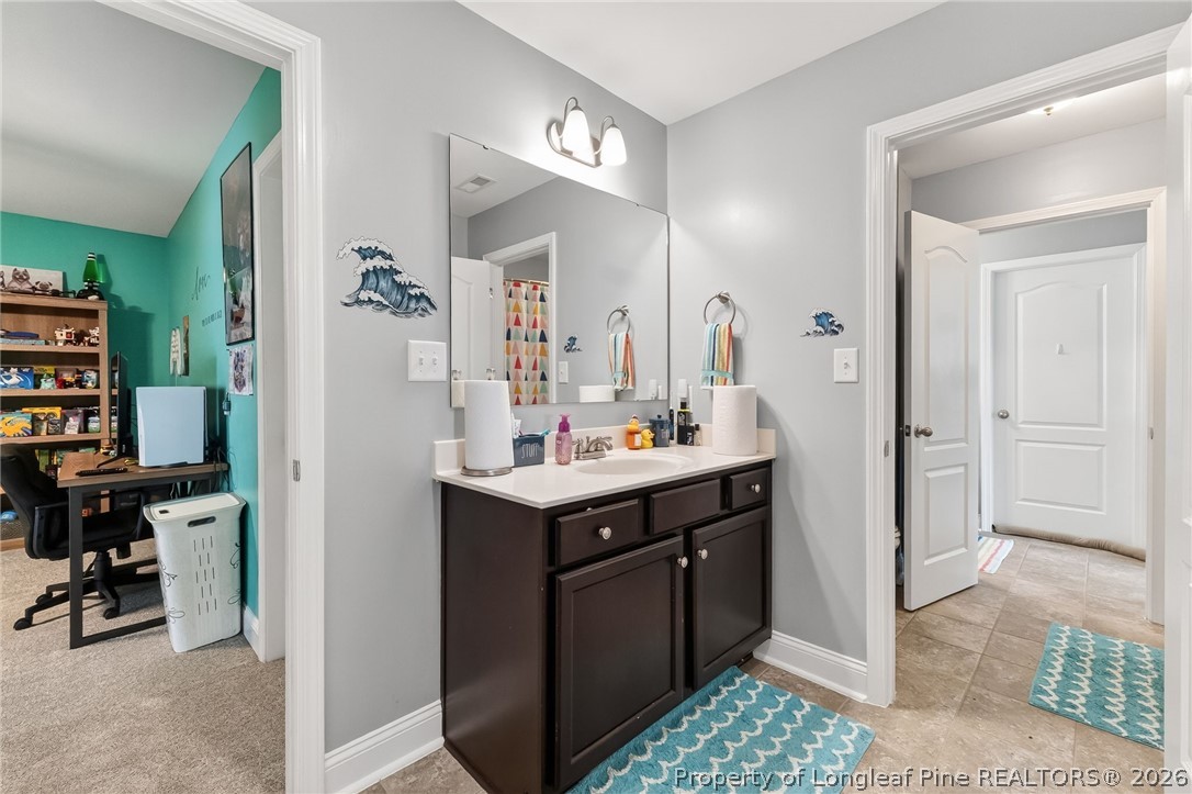 5129 Carson Allen Road Hope Mills, NC 28348 - Photo 32 of 50 a bathroom with a sink a toilet and a mirror