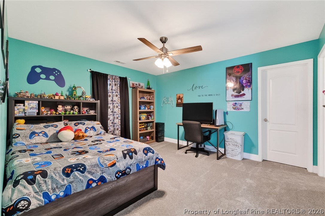 5129 Carson Allen Road Hope Mills, NC 28348 - Photo 34 of 50 a bedroom with a bed and a flat screen tv