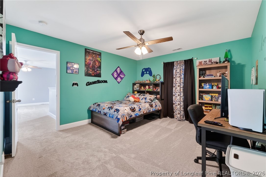5129 Carson Allen Road Hope Mills, NC 28348 - Photo 35 of 50 a bedroom with a bed and a chandelier