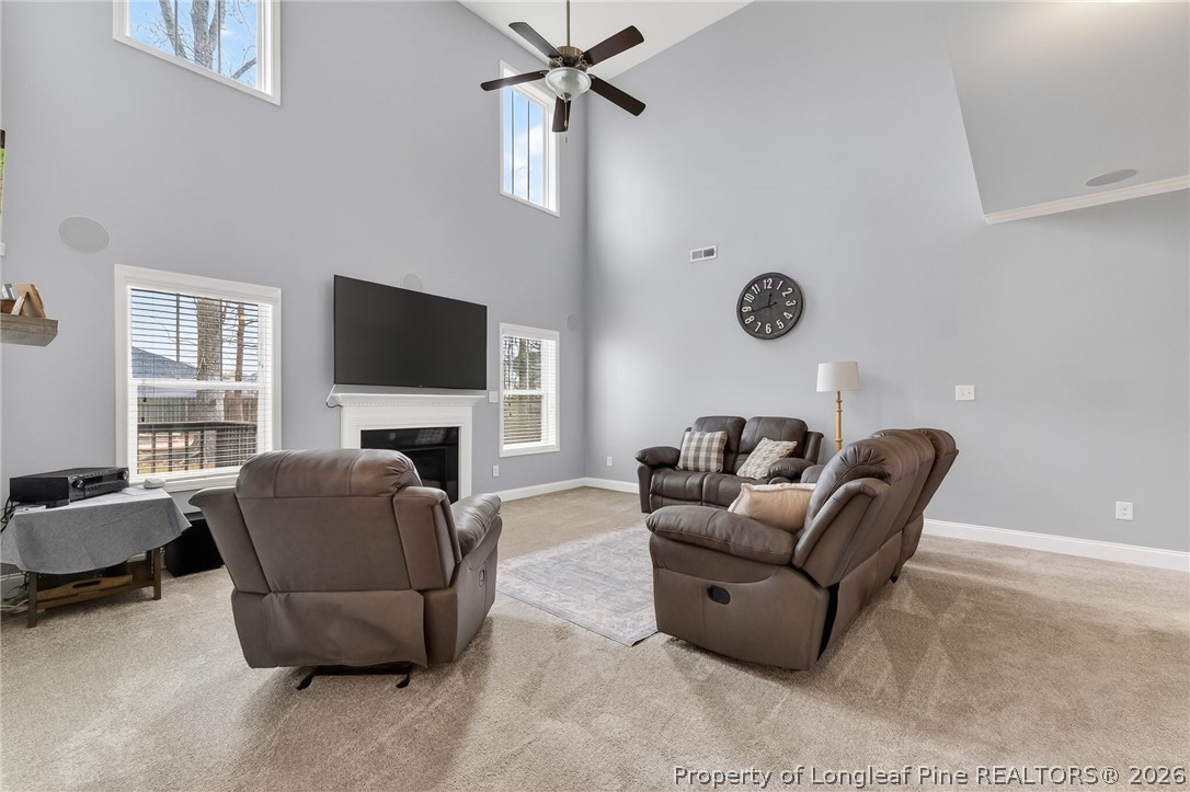 5129 Carson Allen Road Hope Mills, NC 28348 - Photo 5 of 50 a living room with furniture a fireplace and a flat screen tv