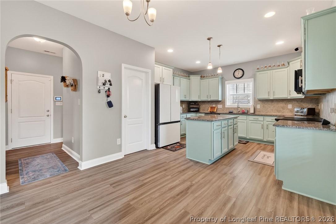 5129 Carson Allen Road Hope Mills, NC 28348 - Photo 6 of 50 a kitchen with stainless steel appliances granite countertop a refrigerator and a stove top oven