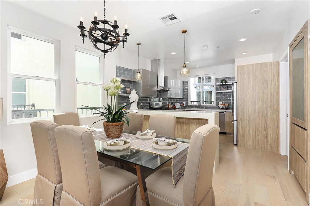9 Turnberry Lane Phillips Ranch, CA 91766 - Photo 34 of 63 a dining room with furniture a chandelier and wooden floor