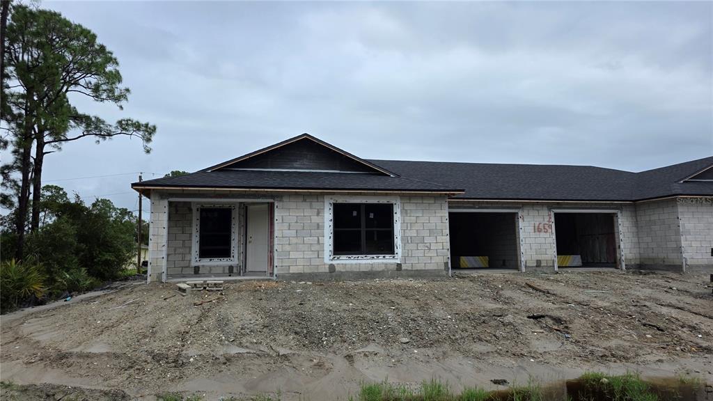 1659 Javier Street, Unit A Palm Bay, FL 32909 - Photo 1 of 6 a view of a house with a yard and garage