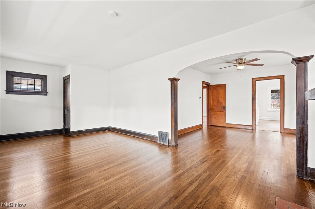 3561 Warren Road Cleveland, OH 44111 - Photo 4 of 28 Living room with dark wood-type flooring, and decorative columns