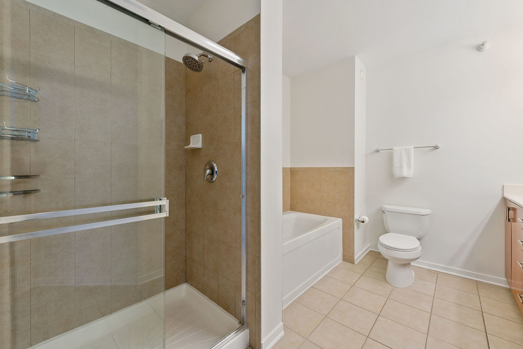 807 Davis Street, Unit 1907 Evanston, IL 60201 - Photo 12 of 20 a bathroom with a sink a toilet and shower