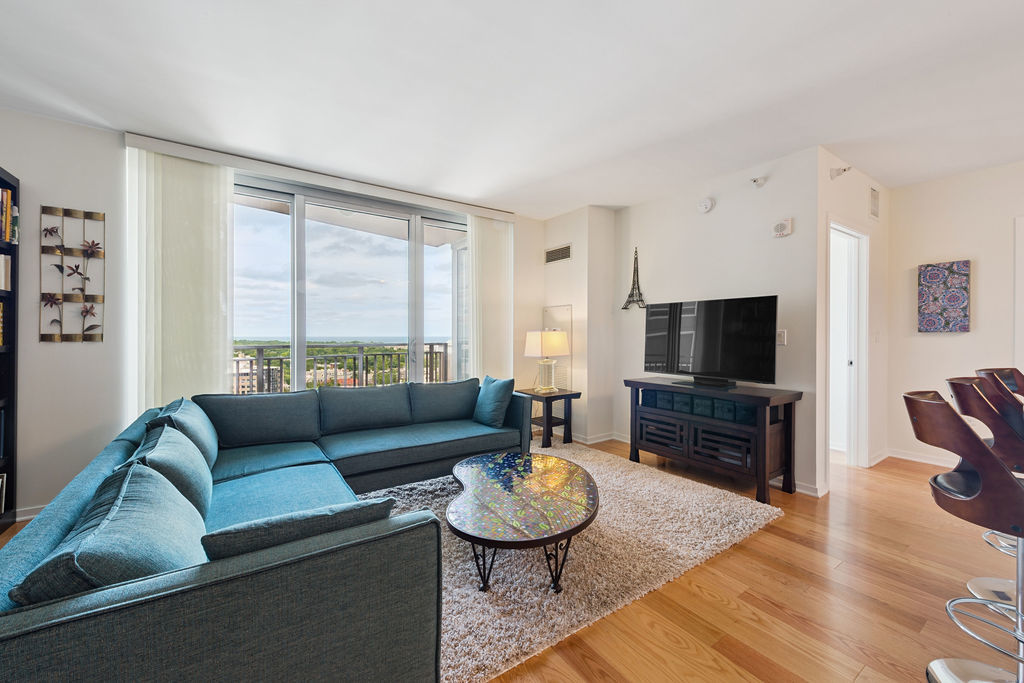 807 Davis Street, Unit 1907 Evanston, IL 60201 - Photo 5 of 20 a living room with furniture and a flat screen tv