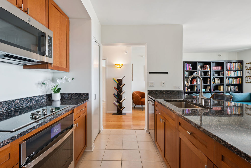 807 Davis Street, Unit 1907 Evanston, IL 60201 - Photo 9 of 20 a kitchen with stainless steel appliances granite countertop a sink and cabinets