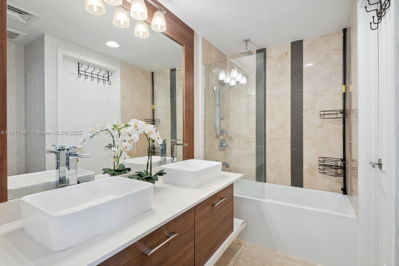 601 Northeast 27th Street, Unit 1406 Miami, FL 33137 - Photo 10 of 13 a bathroom with a bathtub sink and mirror