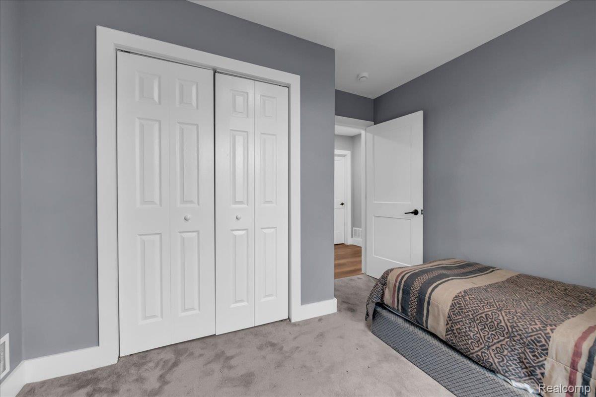 2181 Harding Street Detroit, MI 48214 - Photo 21 of 32 Bedroom featuring light colored carpet and a closet