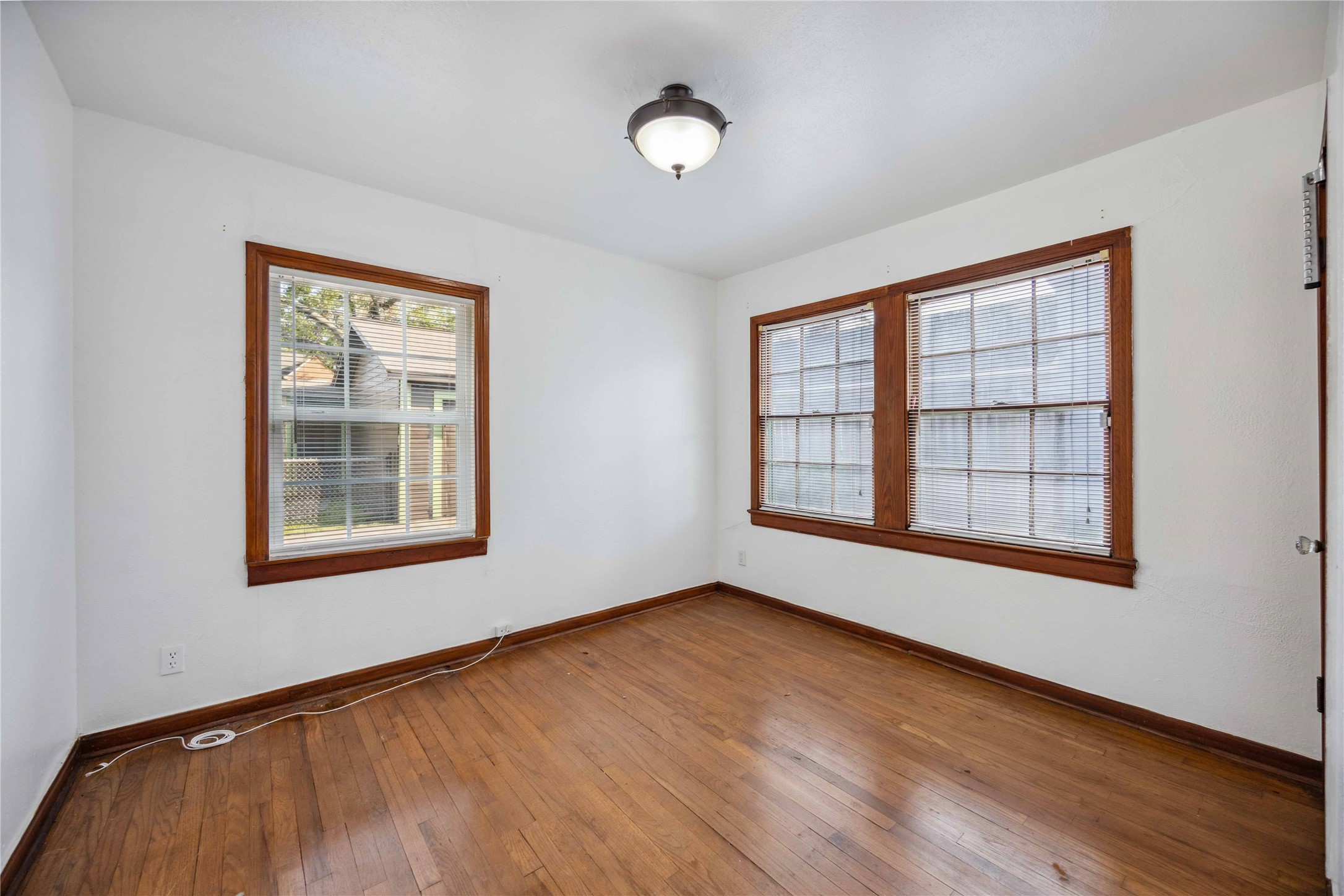 3729 Griggs Road Houston, TX 77021 - Photo 14 of 26 a view of an empty room with wooden floor and a window