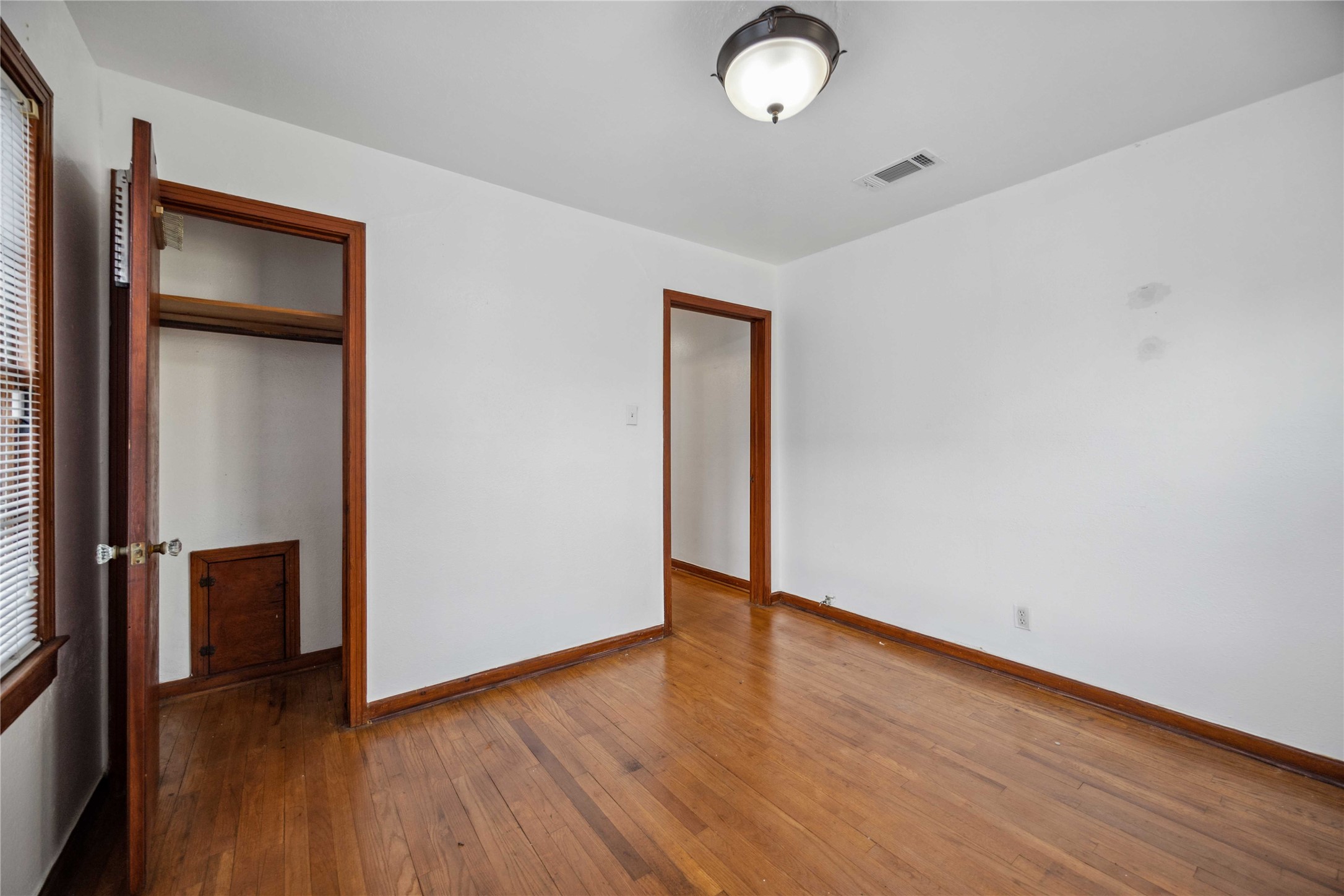 3729 Griggs Road Houston, TX 77021 - Photo 15 of 26 an empty room with wooden floor and windows