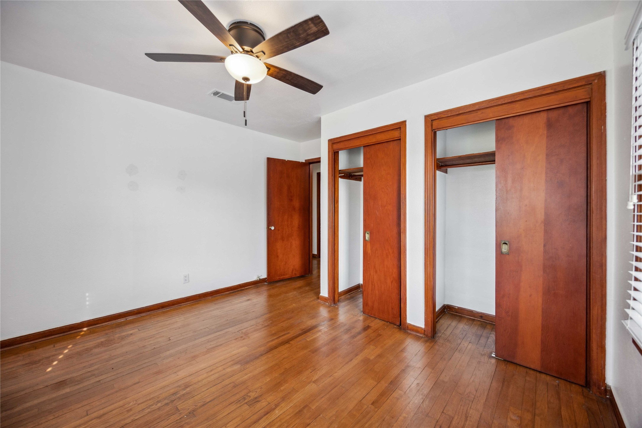 3729 Griggs Road Houston, TX 77021 - Photo 17 of 26 an empty room with wooden floor fan and windows