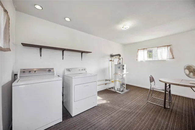 a view of a workspace with furniture and wooden floor