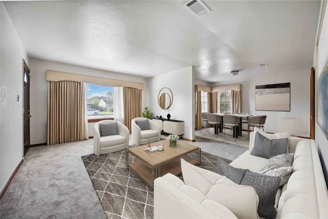 a living room with furniture a rug and a lamp