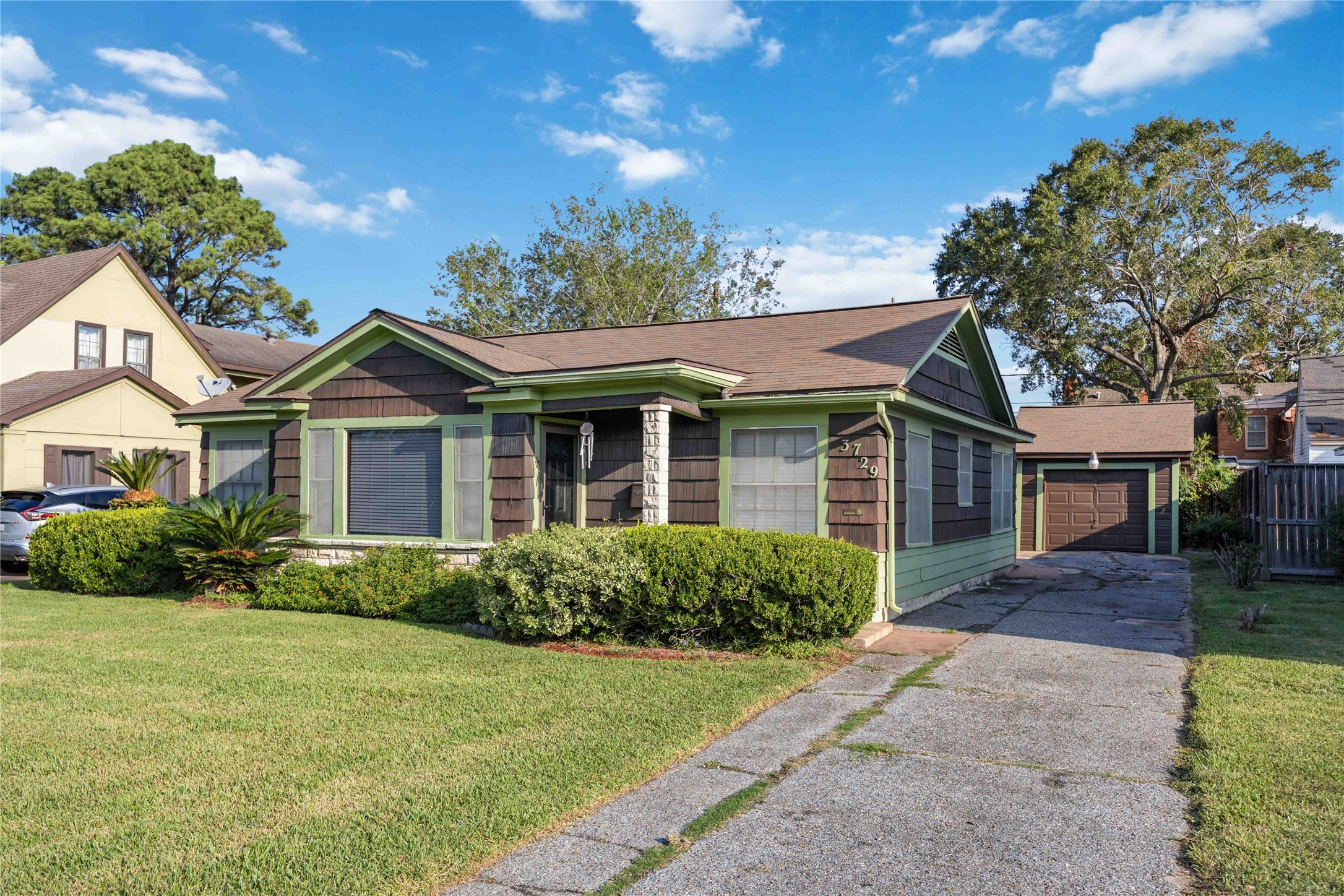 3729 Griggs Road Houston, TX 77021 - Photo 24 of 26 a front view of a house with a yard and potted plants