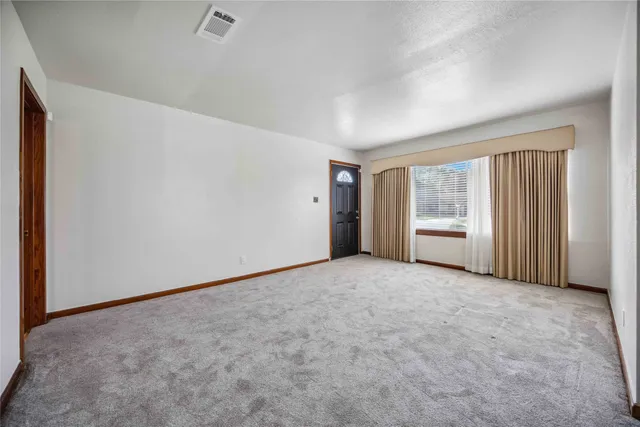 a view of an empty room and a window