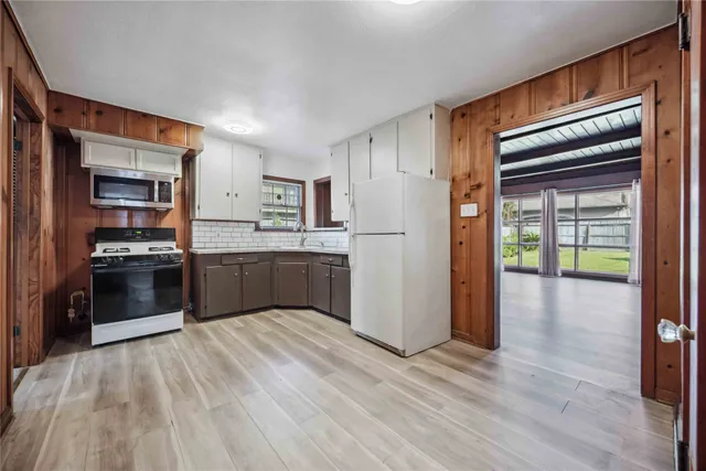 a kitchen with a sink and a stove top oven