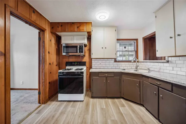 a kitchen with stainless steel appliances granite countertop a stove a refrigerator and a stove top oven