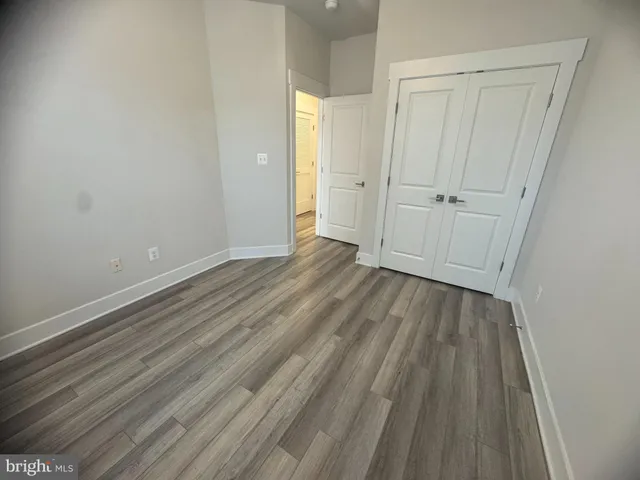 a view of a room with wooden floor and closet