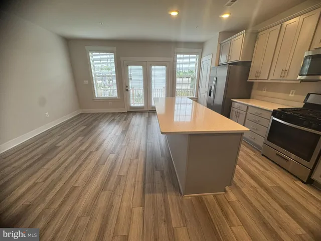 a room with wooden floors and glass windows