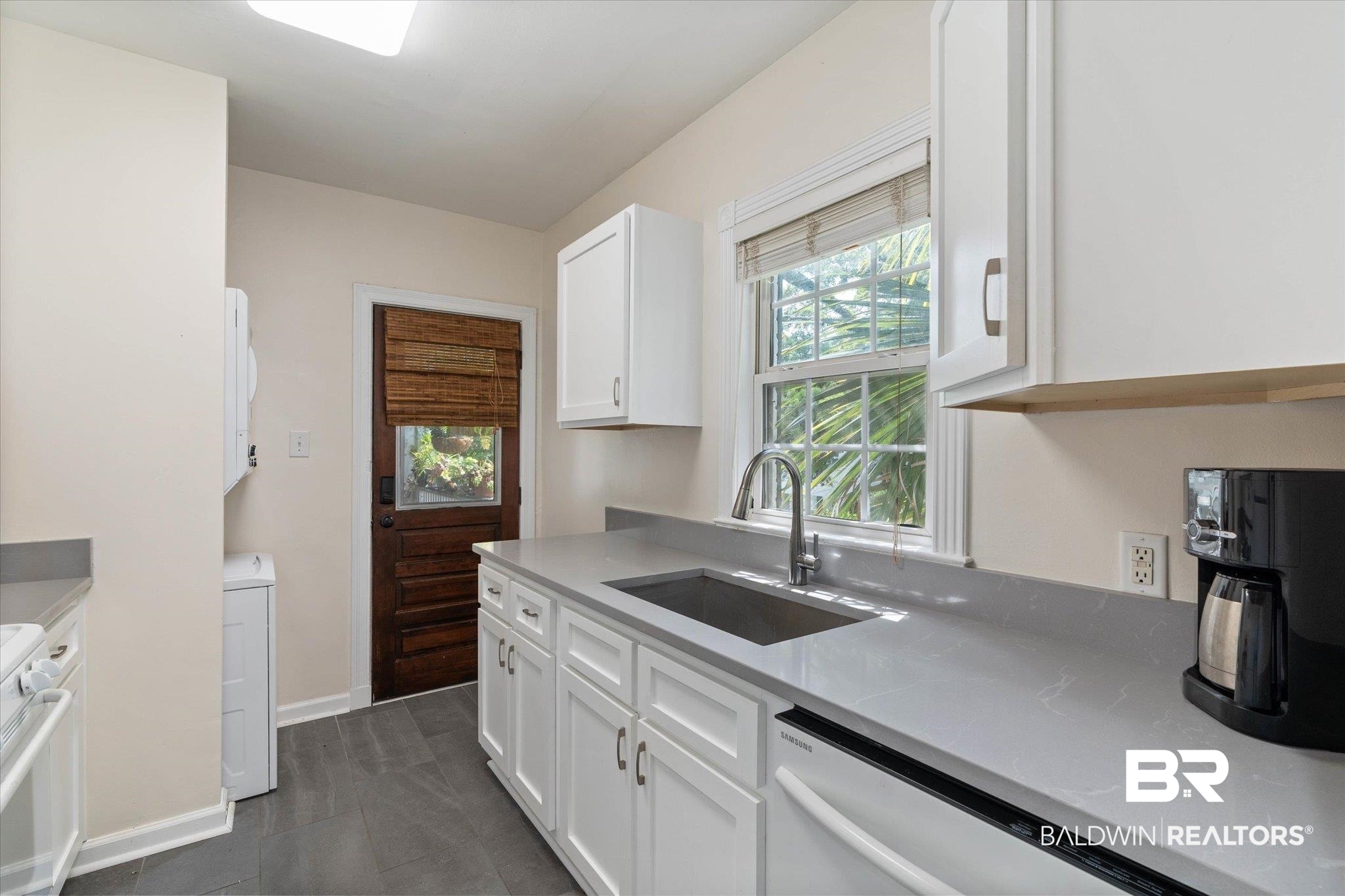 214 Upham Street, Unit 18C Mobile, AL 36607 - Photo 13 of 35 Kitchen featuring a sink, white appliances, white cabinets, and baseboards