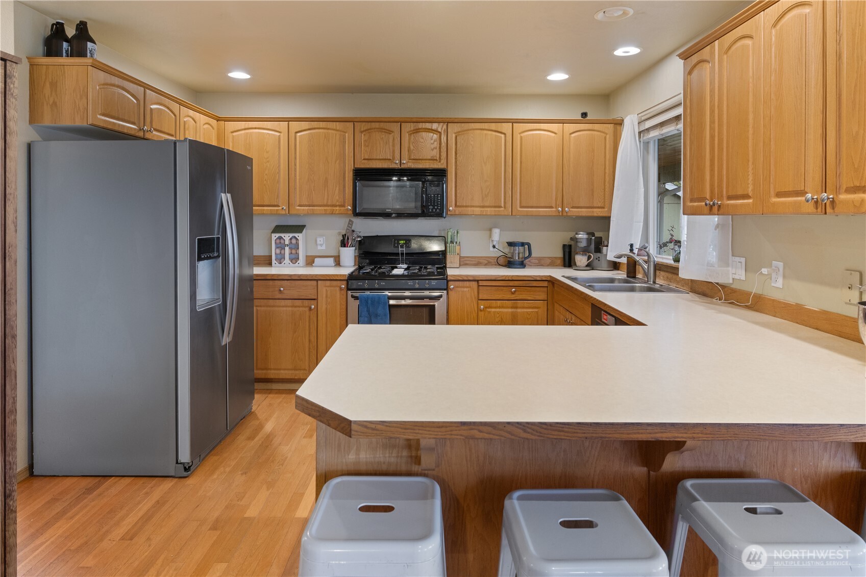 263 Hamilton Court Buckley, WA 98321 - Photo 8 of 35 a kitchen with kitchen island a refrigerator stove and sink