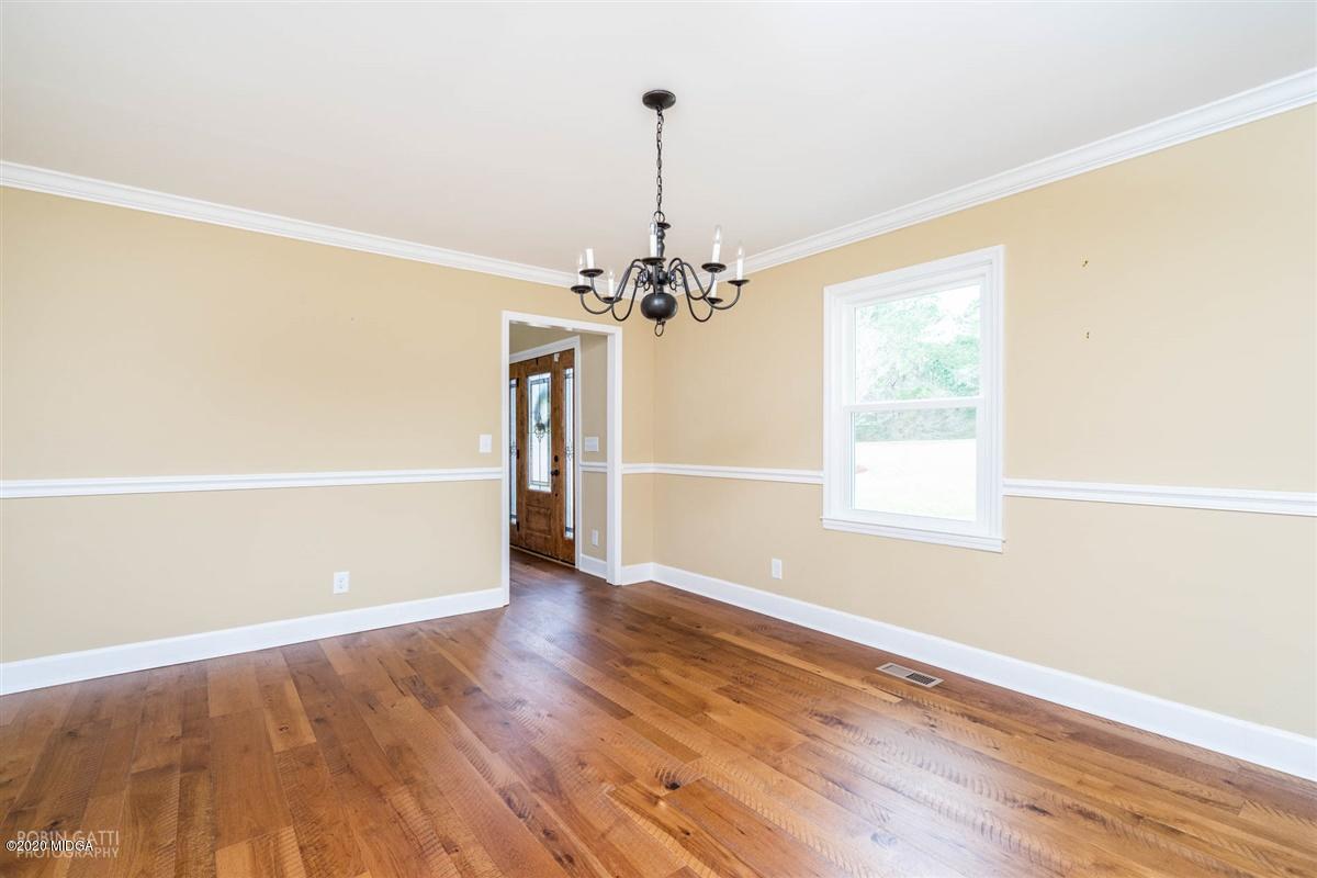 175 Rivoli Ridge Drive Macon, GA 31210 - Photo 14 of 34 a view of a livingroom with wooden floor a ceiling fan and window