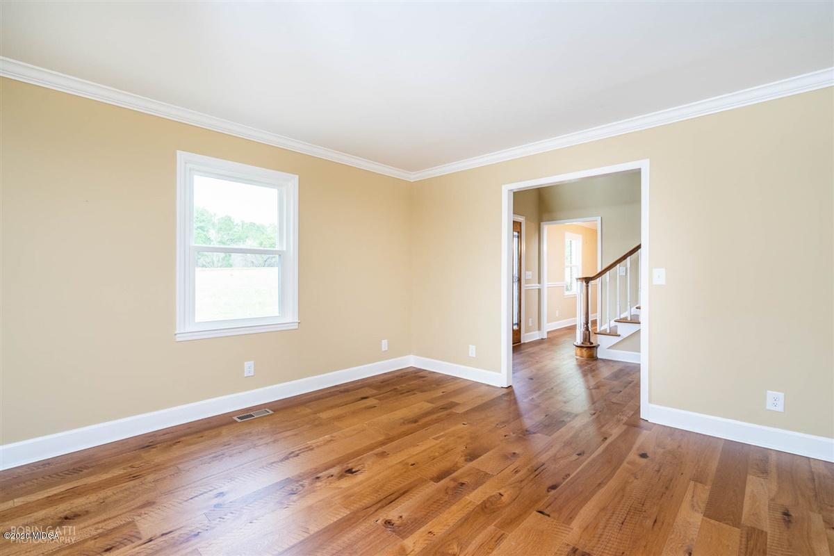 175 Rivoli Ridge Drive Macon, GA 31210 - Photo 3 of 34 an empty room with wooden floor and windows