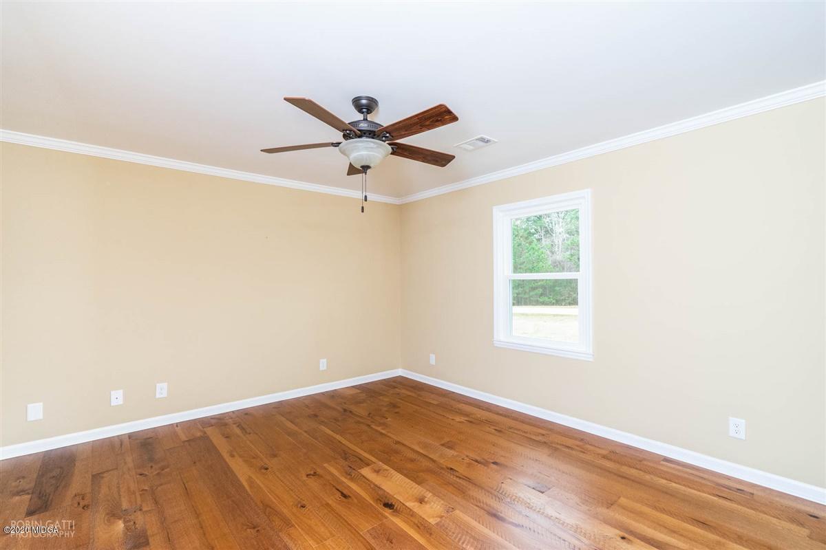 175 Rivoli Ridge Drive Macon, GA 31210 - Photo 22 of 34 a view of a big room with wooden floor and a ceiling fan