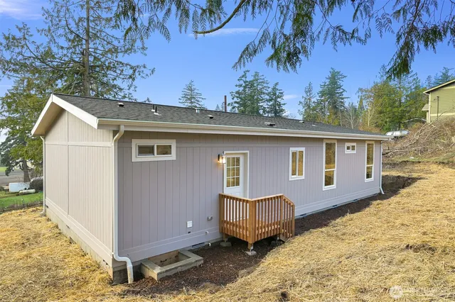 a view of a house with a yard covered in snow