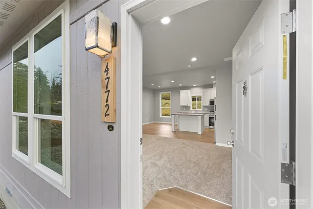 a view of a living room with a fireplace and chandelier