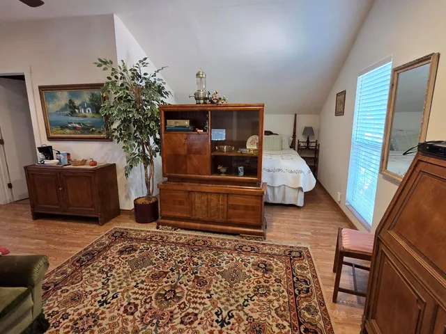 a bedroom with a bed and a mirror