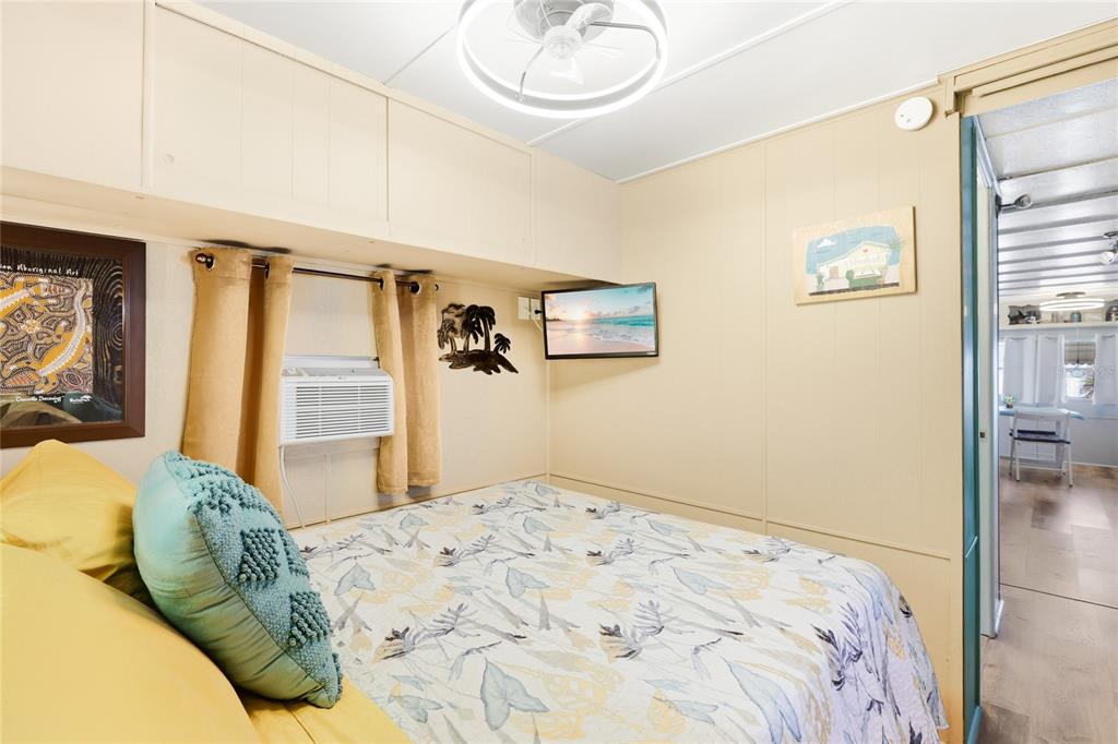 10315 Cortez Road West, Unit 142 Bradenton, FL 34210 - Photo 12 of 22 a bedroom with a bed and a painting on the wall