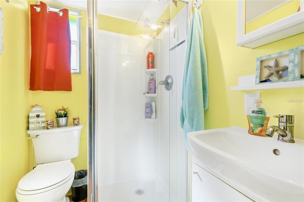 10315 Cortez Road West, Unit 142 Bradenton, FL 34210 - Photo 14 of 22 a bathroom with a sink a toilet and shower curtain
