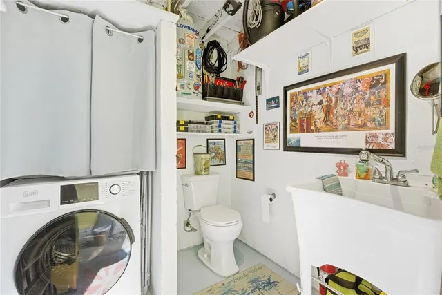 a bathroom with a sink a toilet and a large mirror